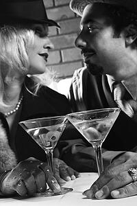 Caucasian prime adult retro male and female looking into eachother's eyes.