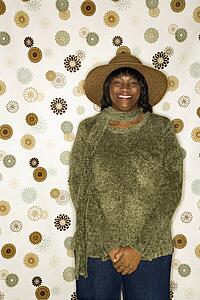 African-American mid-adult woman portrait in front of vintage pattern background.