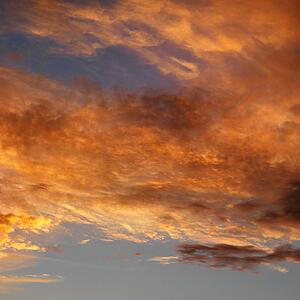 Orange clouds in sky with sunset.