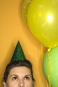 Caucasian prime adult female wearing party hat.
