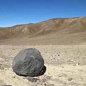 Boulder in barren landscape in Death Valley National Park.