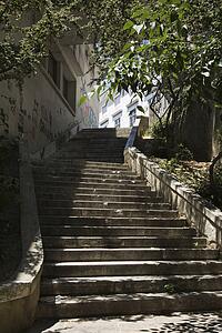 Sun dappled outside steps in Lisbon, Portugal.