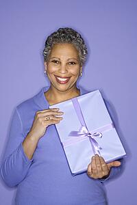 African American mature adult female holding present.