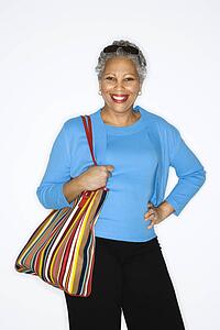 African American mature adult female holding big purse.