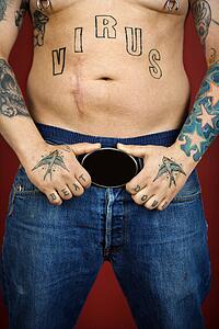 Caucasian mid-adult man with tattoos.