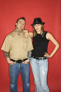 Caucasian mid-adult man and teen female standing together looking at viewer.