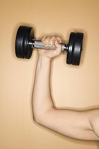 Prime adult Caucasian female arm holding up weight.