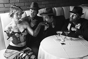 Three Caucasian prime adult males in retro suits wooing Caucasian prime adult female.