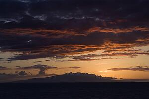 Sunset over Pacific Ocean with clouds in Maui, Hawaii, USA.