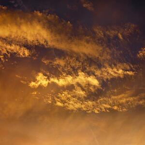 Golden clouds in sky with sunset.