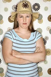 Young Caucasian woman pouting wearing straw hat.