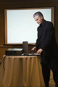 Prime adult Caucasian businessman giving presentation.