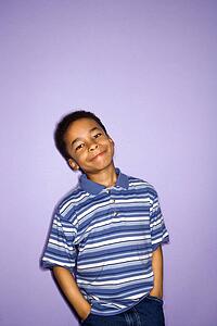 Portrait of young boy with hands in pockets.