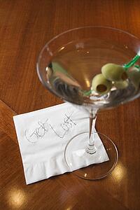 Martini and note on napkin reading 'get lost. '