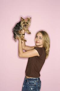 Caucasian young adult female with Yorkshire Terrier dog.