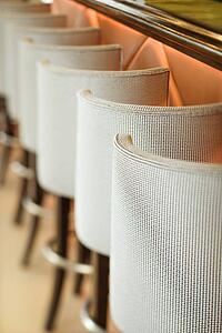 Stools lined up at bar.