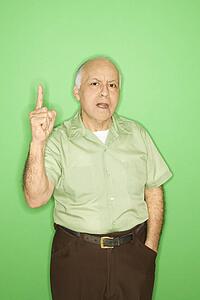 Caucasian mature adult male holding up one finger.