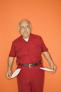 Mature adult Caucasian male pulling out empty pockets.