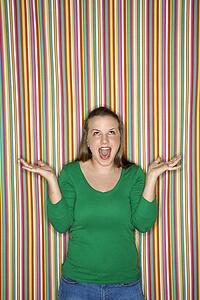 Young Caucasian female adult shrugging and making facial expression.