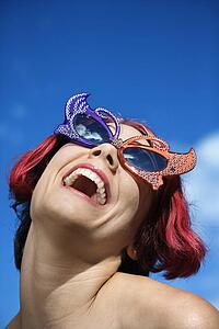 Close up of young adult Caucasian female wearing unique vintage glasses.