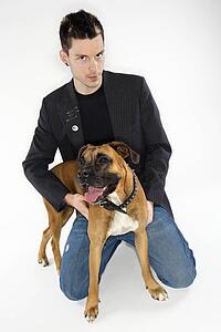 Young adult Caucasian male with Boxer dog.