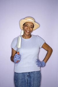 African American mature adult female with hand shovel.