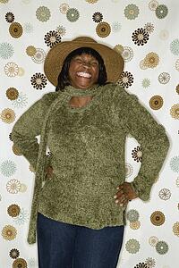 African-American mid-adult woman in front of vintage pattern background.