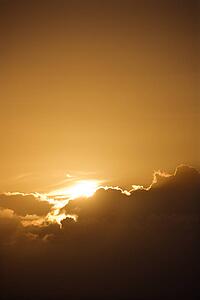 Sun peeking through cloud.