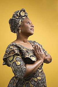 African American mature adult female dressed in African costume.