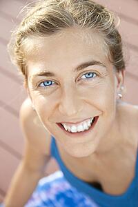 Close-up of Caucasian mid-adult woman smiling and looking at viewer.