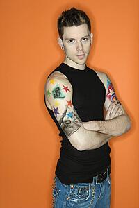 Young adult Caucasian male with tattoos.