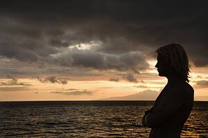 Male standing on the shore of Maui Hawaii USA