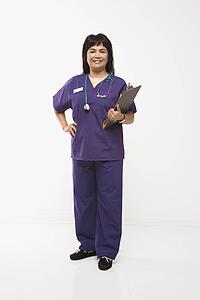 Middle-aged Filipino woman dressed in scrubs with stethoscope and clipboard.