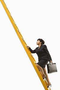 Filipino middle-aged businesswoman climbing ladder carrying briefcase.