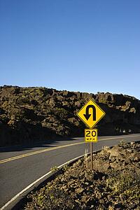 Road and curve in road sign in Haleakala National Park, Maui, Hawaii.