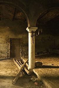 Sunlight filling old abandoned building with column and arches in Tuscany, Italy. 