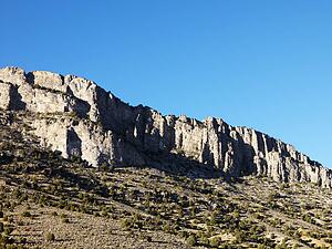 Mountain range against clear blue sky.