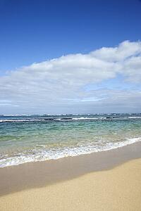 Landscape of waves lapping on beach.
