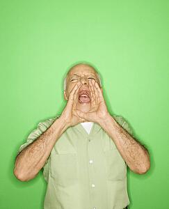 Caucasian mature adult male with hands to mouth yelling.