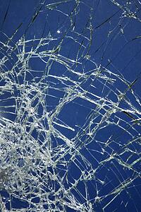 Cracked glass against blue background.