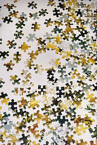 Still life of puzzle pieces on table.