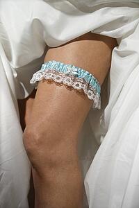 Close-up image of bride's leg with garter.