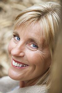 Head shot of middle-aged Caucasian woman smiling.