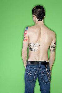 Rear view of tattooed young adult Caucasian male.