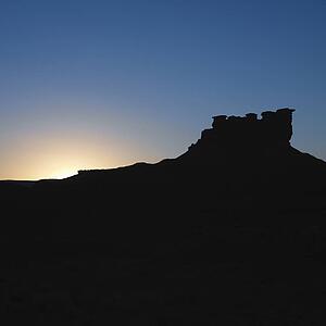 Silhouette of Garden of the Gods rock formation at dusk in Monument Valley, Utah.