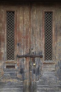 Exterior locked doors with worn paint in Lisbon, Portugal.