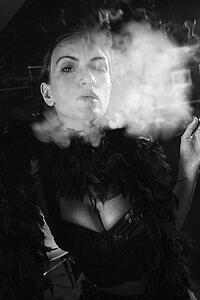 Caucasian prime adult female smoking looking at viewer.