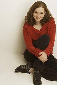 A woman casually sitting on the ground