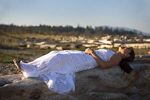 A Filipino woman wearing a white dress on the beach
