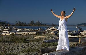 Woman praying at the beach
